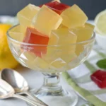 Homemade sugar-free jello cubes in a glass bowl, colorful and glossy