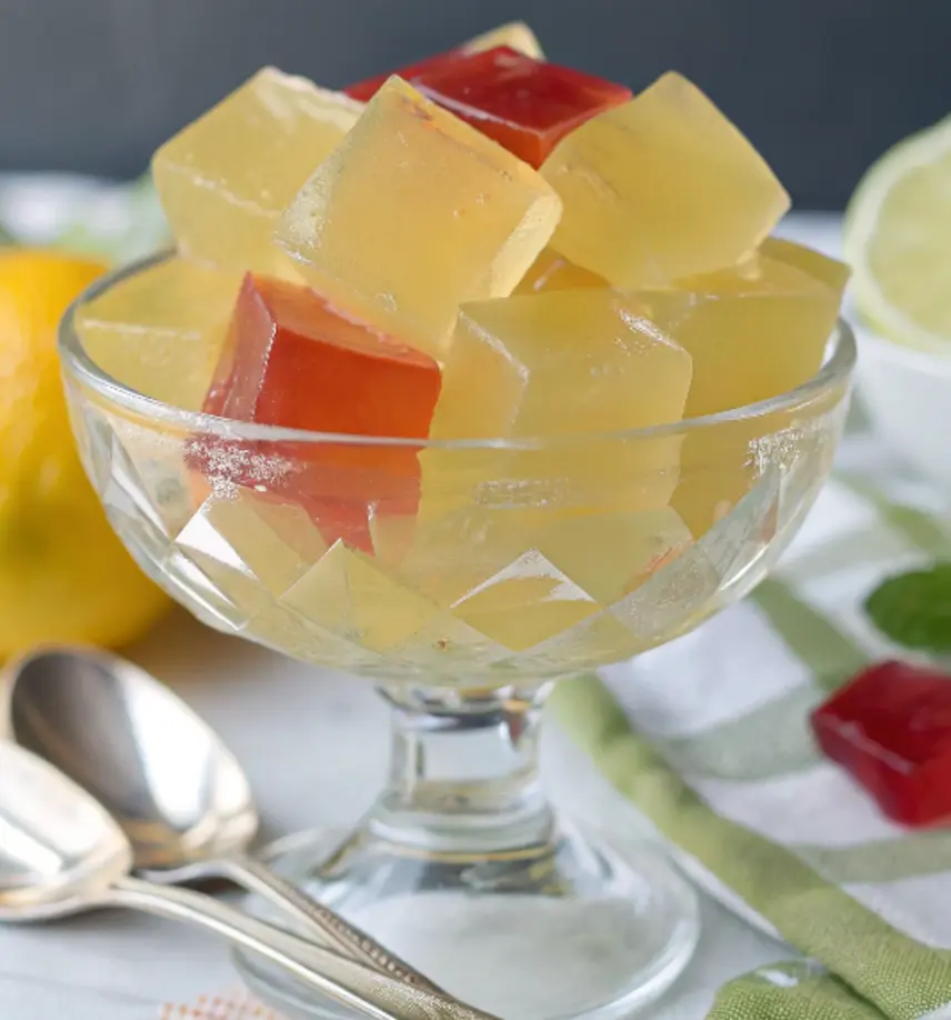 Homemade sugar-free jello cubes in a glass bowl, colorful and glossy